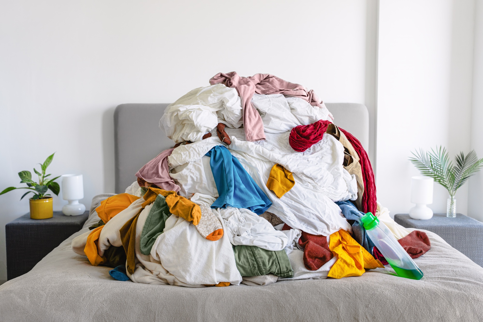 Pile of Unsorted Laundry on a Bed